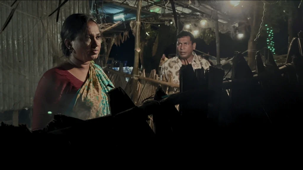 Roobena Reza Jui and Mosharraf Karim in a still from Bangladeshi short film Abarta – The Circle, showing a woman’s silent struggle in a small kitchen. Selected for CineCi’ 2025.