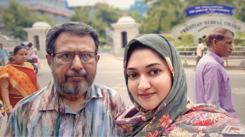 Father and daughter standing in front of a hospital in vellore, chennail, india