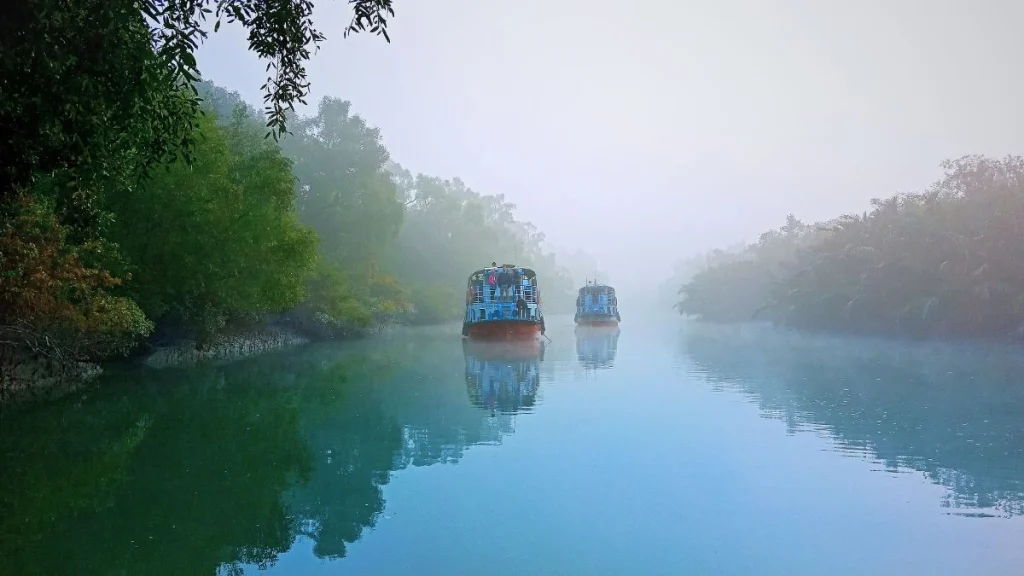Tourist boat on a Sundarban river in Bangladesh, with boatmen, fishermen, and visitors all relying on the river for travel and livelihood.